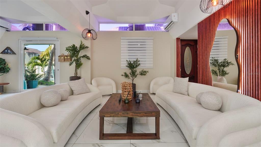 A living room features two curved white sofas, a wooden coffee table, and tile flooring — G-6 LOMBARDIA STREET, NAGUABO, PR