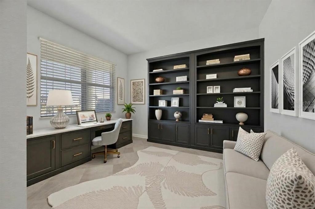 A home office features built-in black cabinetry, a desk, a sofa, and a patterned rug — 9070 SW 106TH AVENUE, OCALA, FL