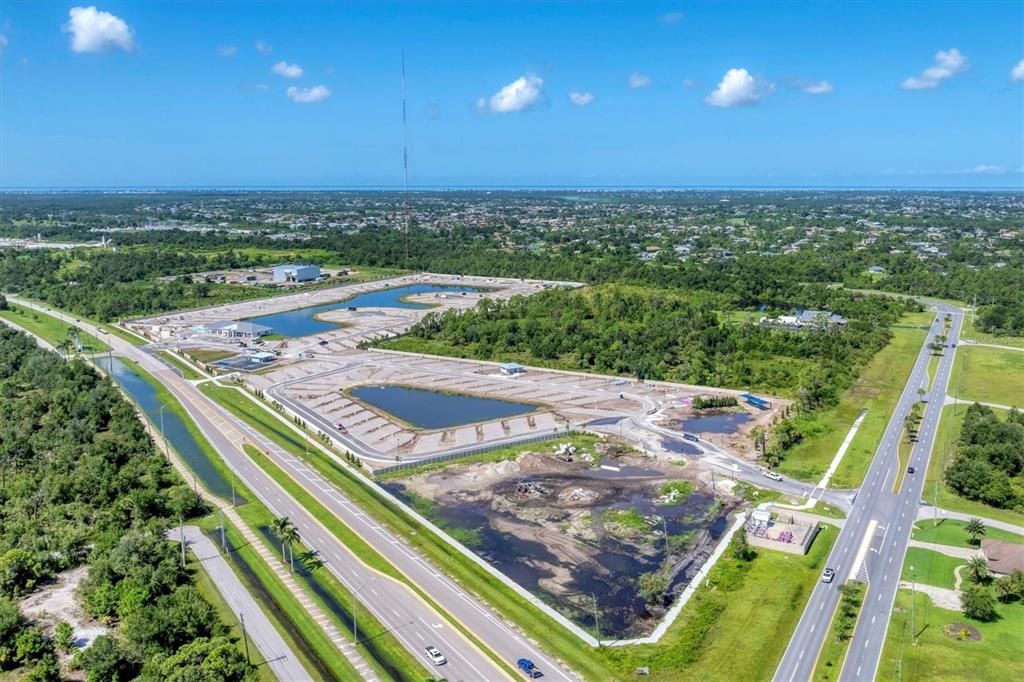 An aerial view shows a construction site with two retention ponds and paved parking areas — 9001 GASPARILLA ROAD UNIT 80, PLACIDA, FL