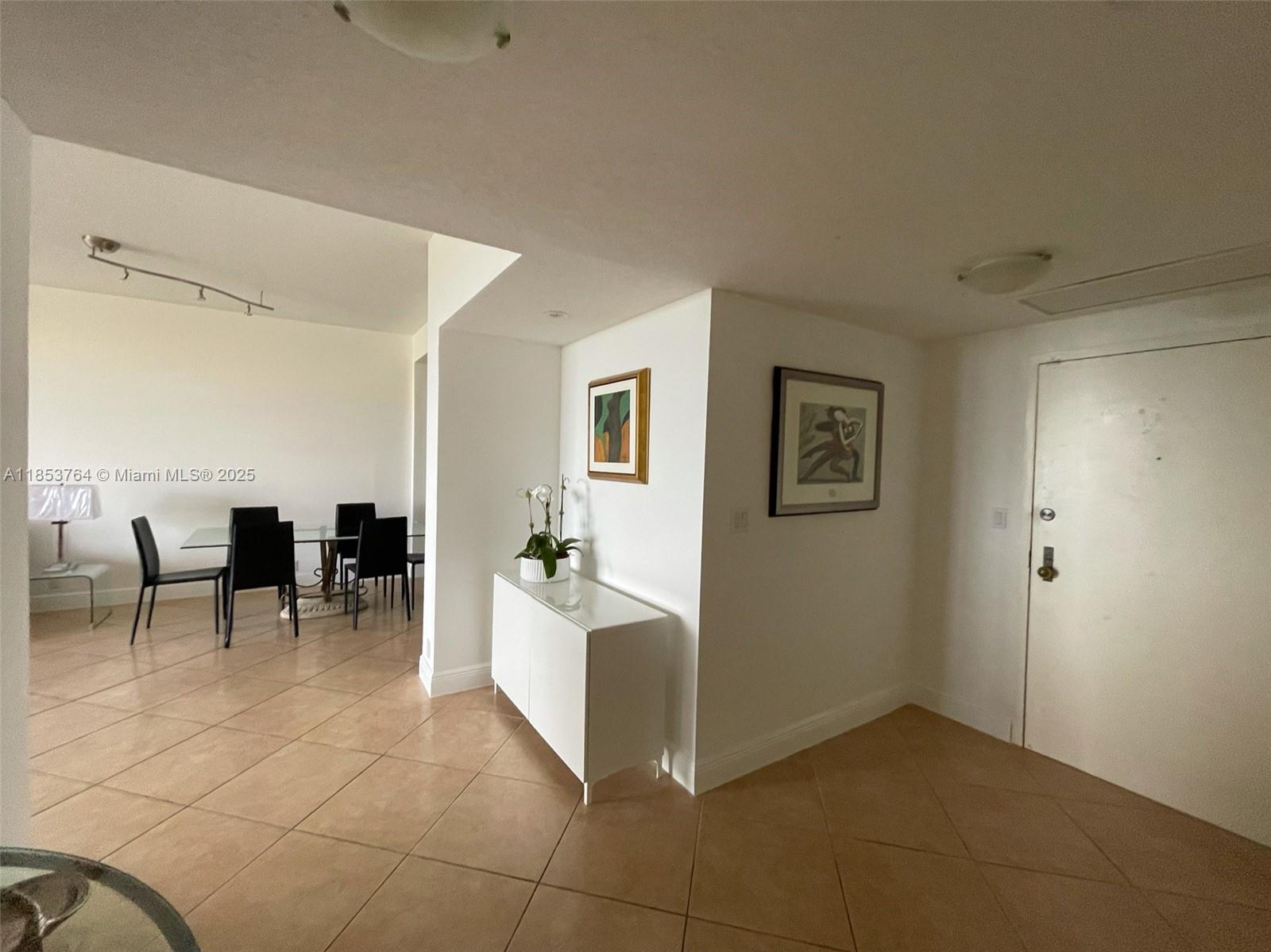 An entryway leads to a dining area with tile floors and white walls — 151 Crandon Blvd # 833, Key Biscayne FL 33149, KEY BISCAYNE, FL