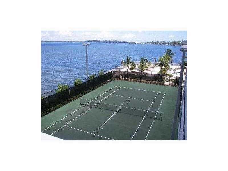 A tennis court sits next to a body of water with a bridge in the distance — 2101 Brickell Avenue # 808, Miami FL 33129, MIAMI, FL