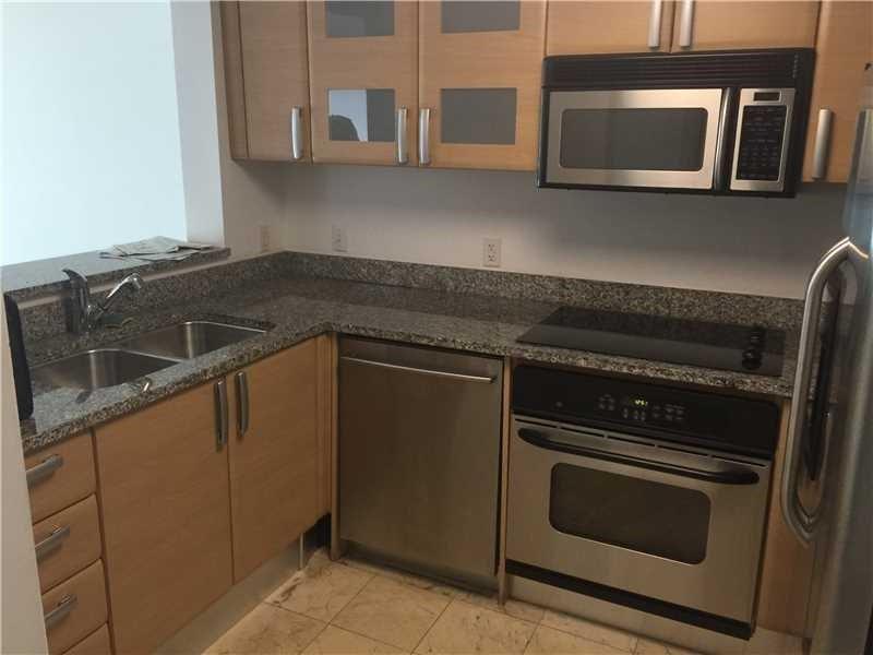 A kitchen with light wood cabinets, granite countertops, and stainless steel appliances — 2101 Brickell Avenue # 808, Miami FL 33129, MIAMI, FL