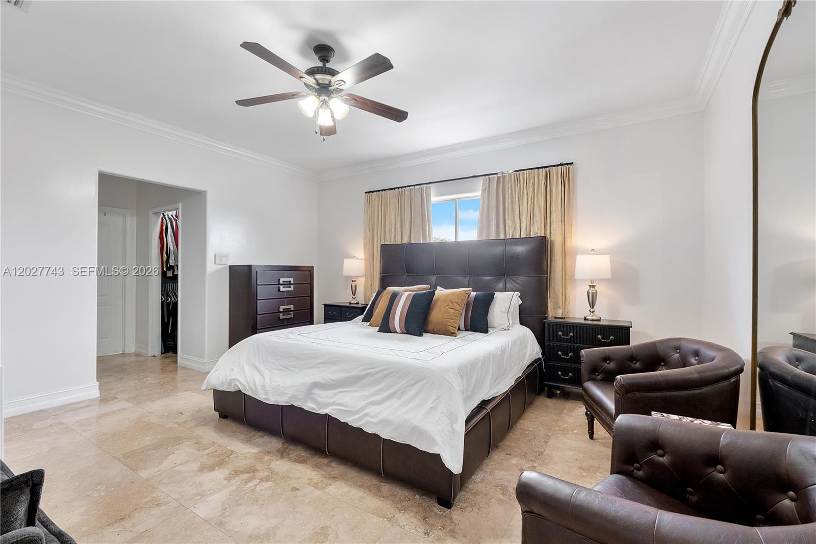 A bedroom features a dark leather bed, matching furniture, two armchairs, and tile flooring — 16732 NW 89th Pl, Miami Lakes FL 33018, MIAMI LAKES, FL