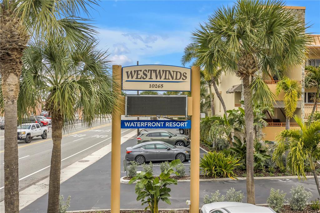 A sign for Westwinds Waterfront Resort stands in front of a parking lot and street — 10265 GULF BOULEVARD UNIT B315, ST PETERSBURG, FL
