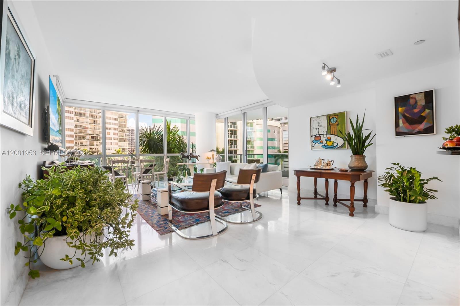 A bright living room features white marble floors, floor-to-ceiling windows, and modern furniture — 1331 Brickell Bay Dr # 408, Miami FL 33131, MIAMI, FL