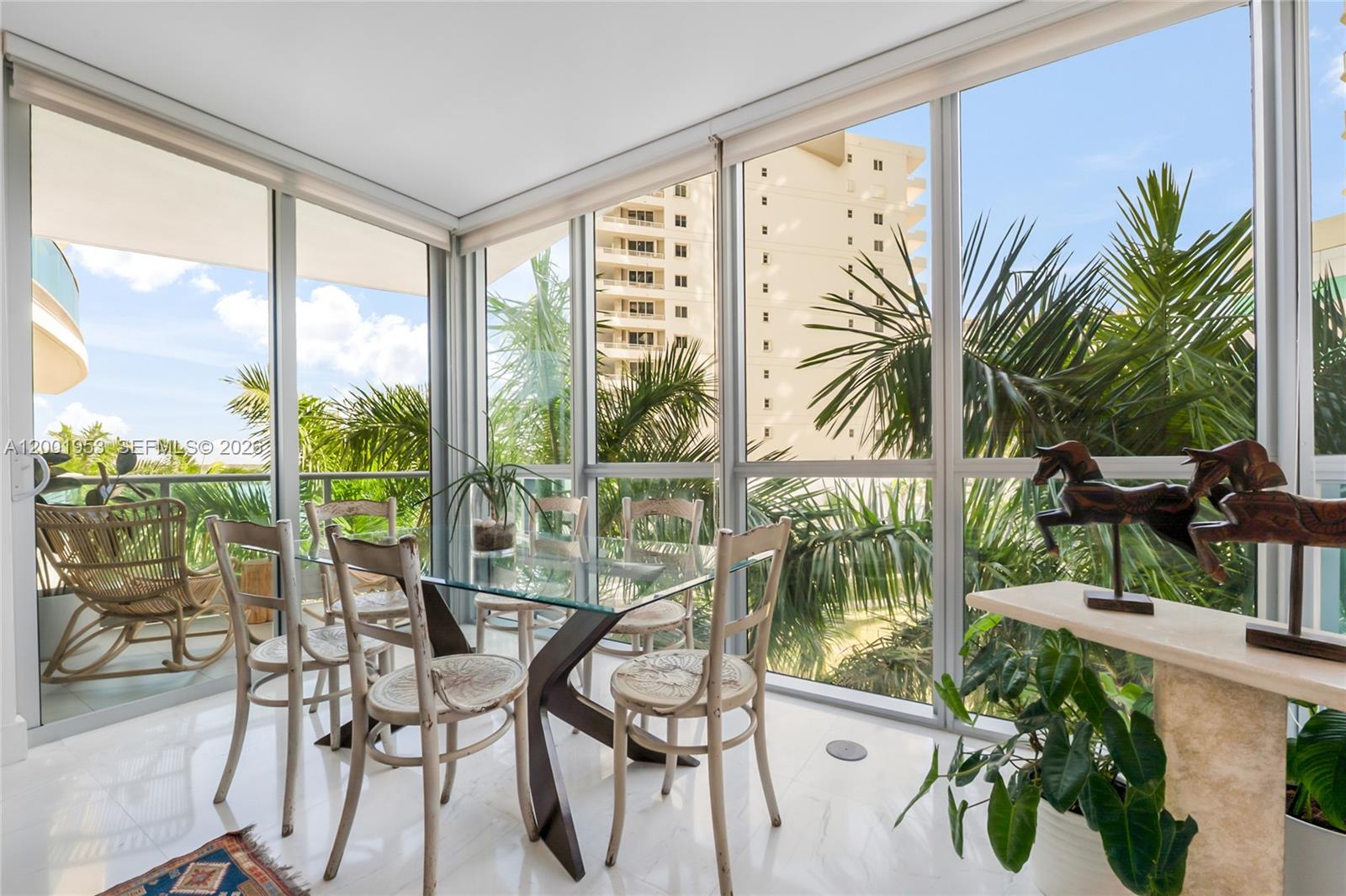 A sunroom with a glass dining table, white tile floors, and floor-to-ceiling windows — 1331 Brickell Bay Dr # 408, Miami FL 33131, MIAMI, FL