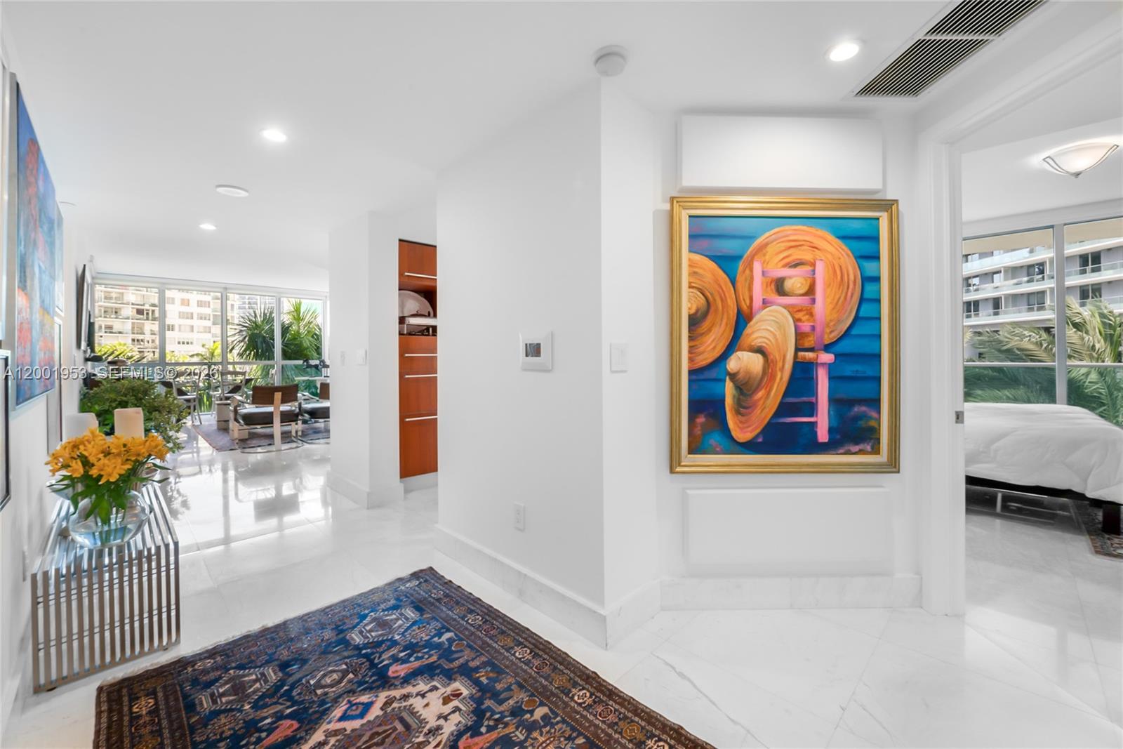 A bright hallway with white tile floors leads to a living area and bedroom — 1331 Brickell Bay Dr # 408, Miami FL 33131, MIAMI, FL