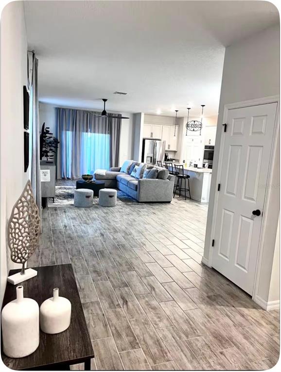 An entryway leads into a living room with tile flooring and a sliding glass door — 158 ABERDEEN STREET, DAVENPORT, FL