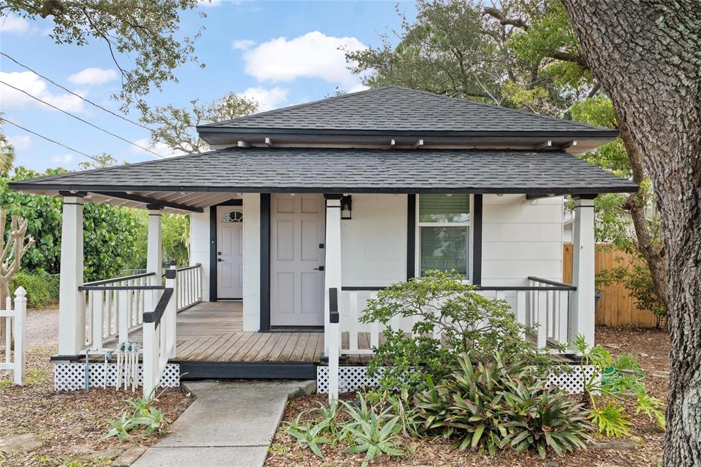 A small white house with a dark roof and a wooden front porch — 136 N RING AVENUE, TARPON SPRINGS, FL