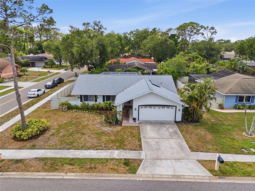An aerial view of a single-story suburban house with a white exterior and gray roof — 3052 HERON PLACE, CLEARWATER, FL