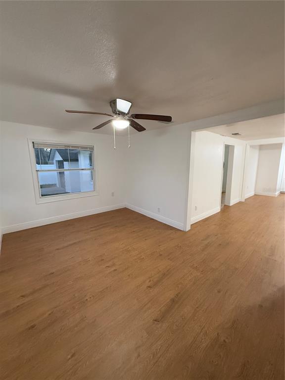 An empty room with light wood-look flooring, white walls, and a ceiling fan — 636 COKE AVENUE, WINTER GARDEN, FL