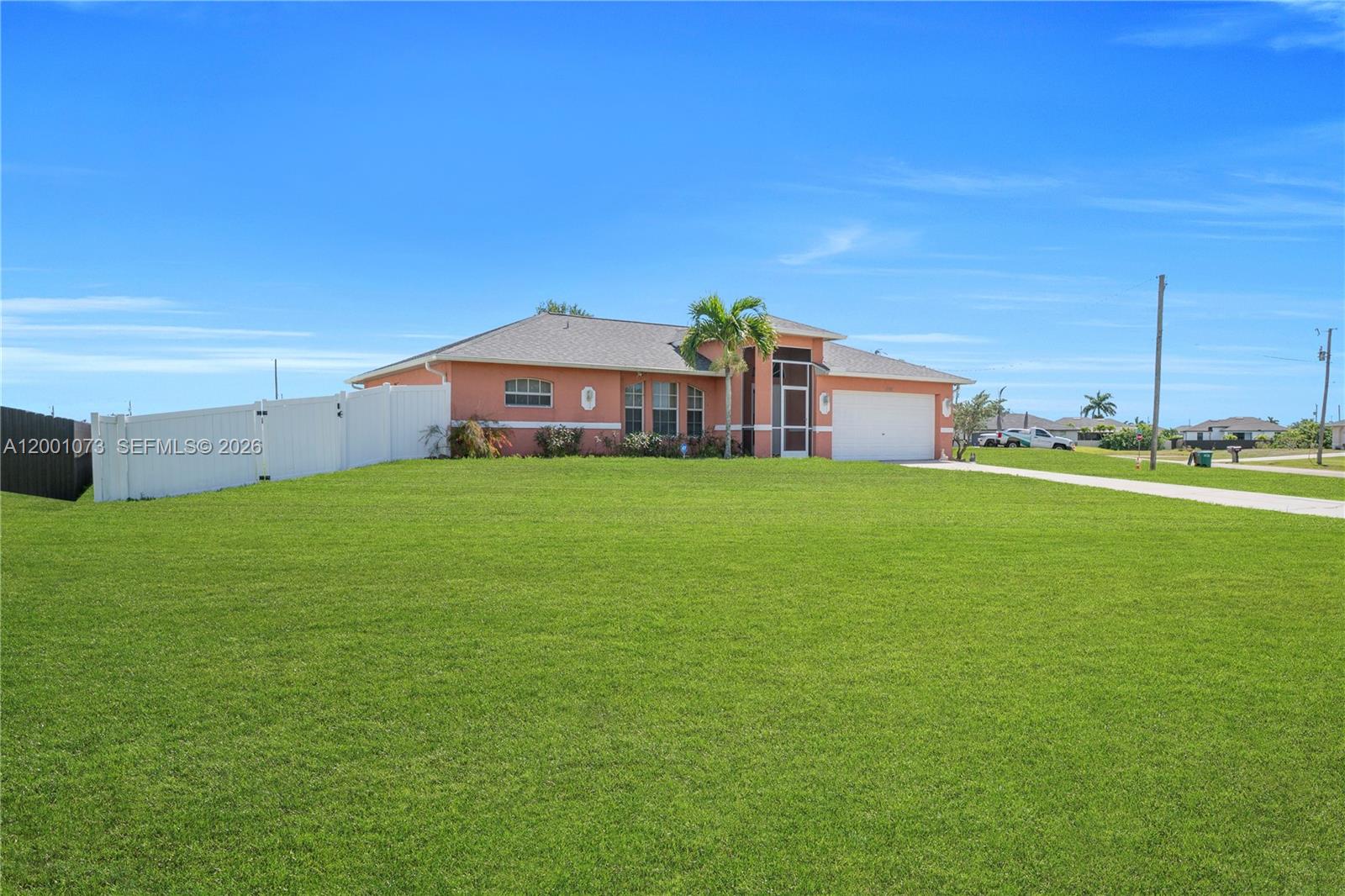 A single-story peach-colored house with a white fence and a large front lawn — 2840 NW 2ND TERRACE, Cape Coral FL 33993, CAPE CORAL, FL