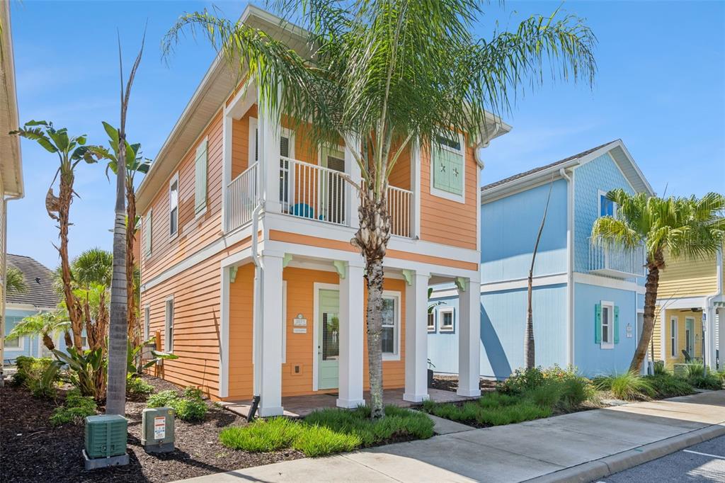 A two-story orange house with a balcony and a light green front door — 3071 KEY LIME LOOP, KISSIMMEE, FL