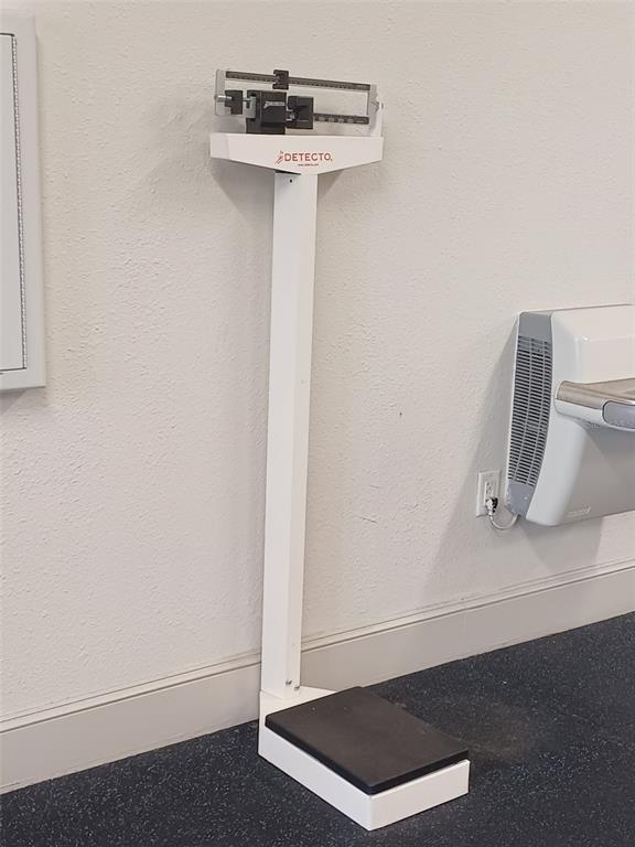 A white Detecto physician's scale stands against a wall next to a water fountain — 3005 RED GINGER ROAD, KISSIMMEE, FL