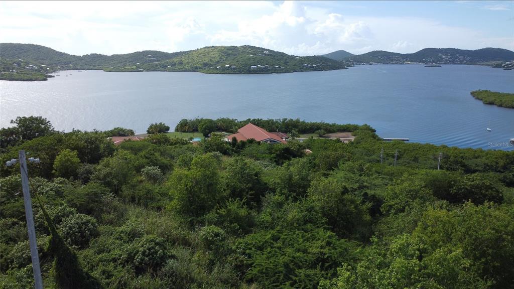 An aerial view of a coastal property featuring a house surrounded by lush green vegetation — 1 BARRIO FRAILES, CULEBRA, PR