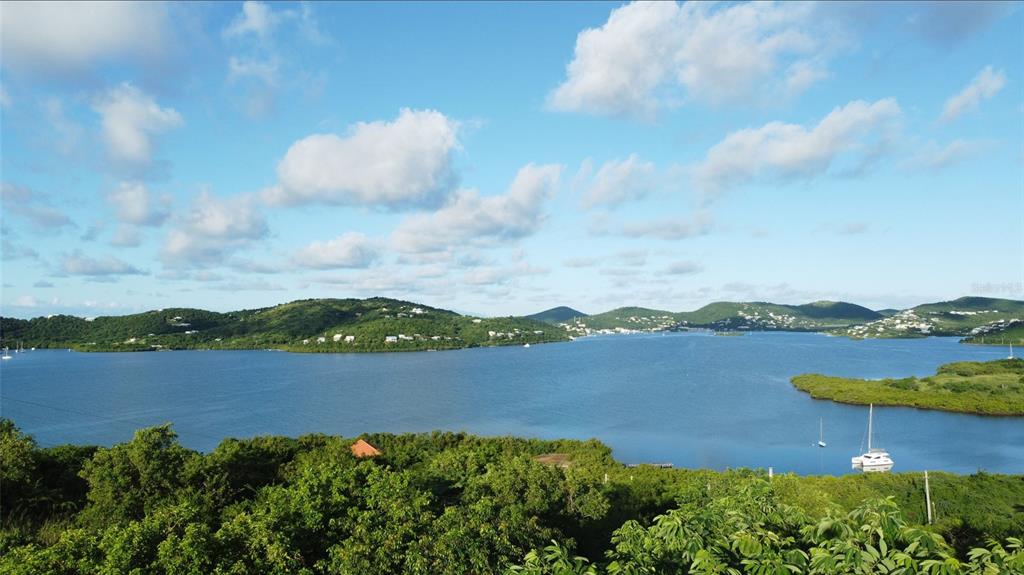 A scenic view of a bay surrounded by lush green hills under a cloudy sky — 1 BARRIO FRAILES, CULEBRA, PR