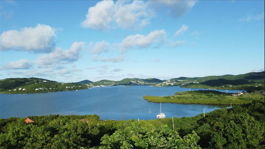 A high-angle view of a calm bay surrounded by green hills and scattered boats — 1 BARRIO FRAILES, CULEBRA, PR