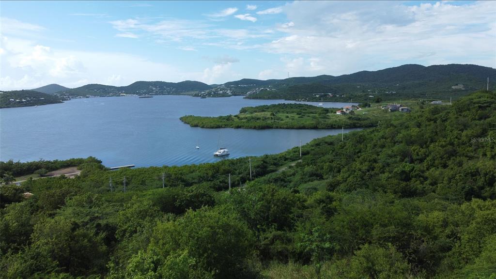 An aerial view of a coastal bay surrounded by lush green hills and a boat — 1 BARRIO FRAILES, CULEBRA, PR