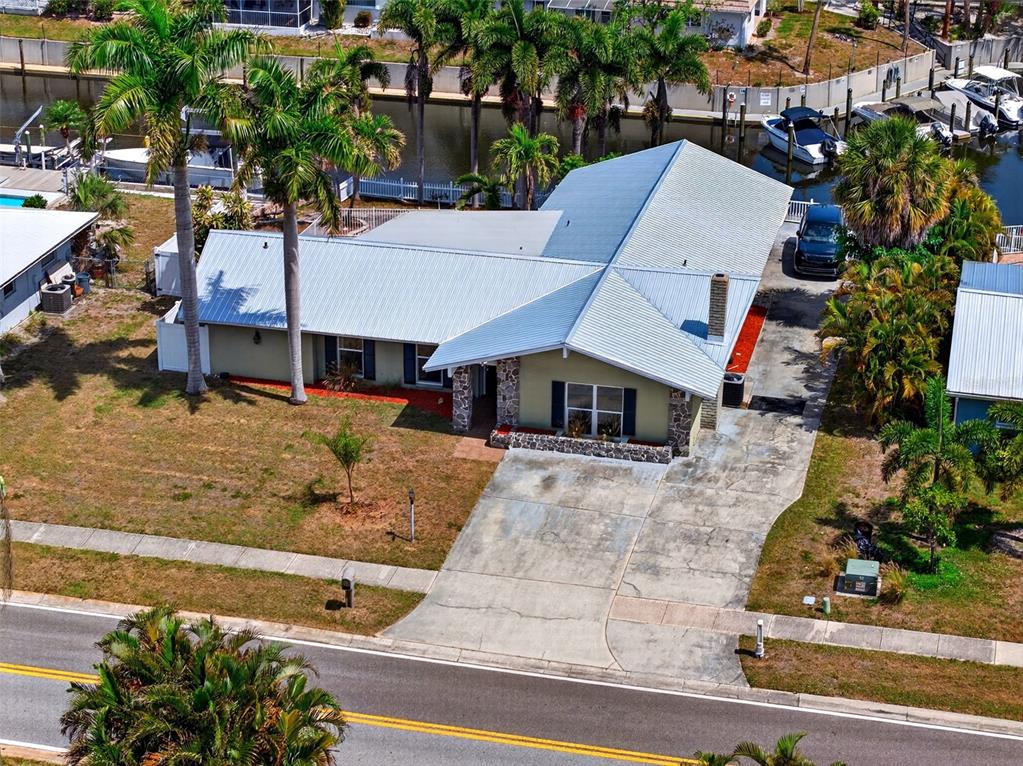 An aerial view of a single-story house with a metal roof and a concrete driveway — 2555 CONSTITUTION BOULEVARD, SARASOTA, FL