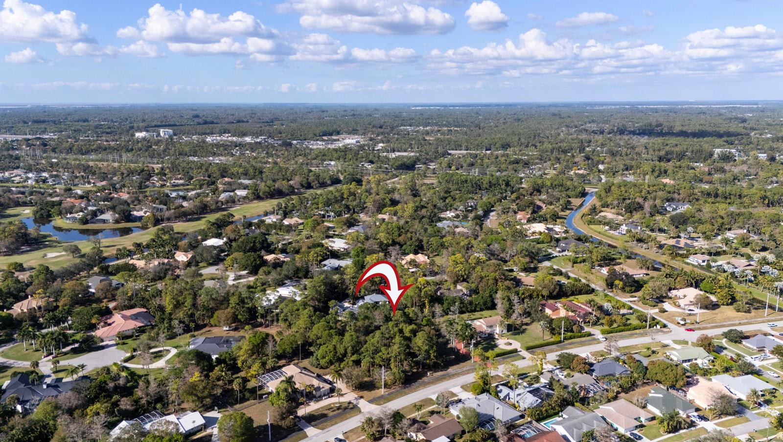 An aerial view shows a residential property surrounded by dense trees and nearby suburban homes — 14779 Paddock Drive, Wellington FL 33414, WELLINGTON, FL
