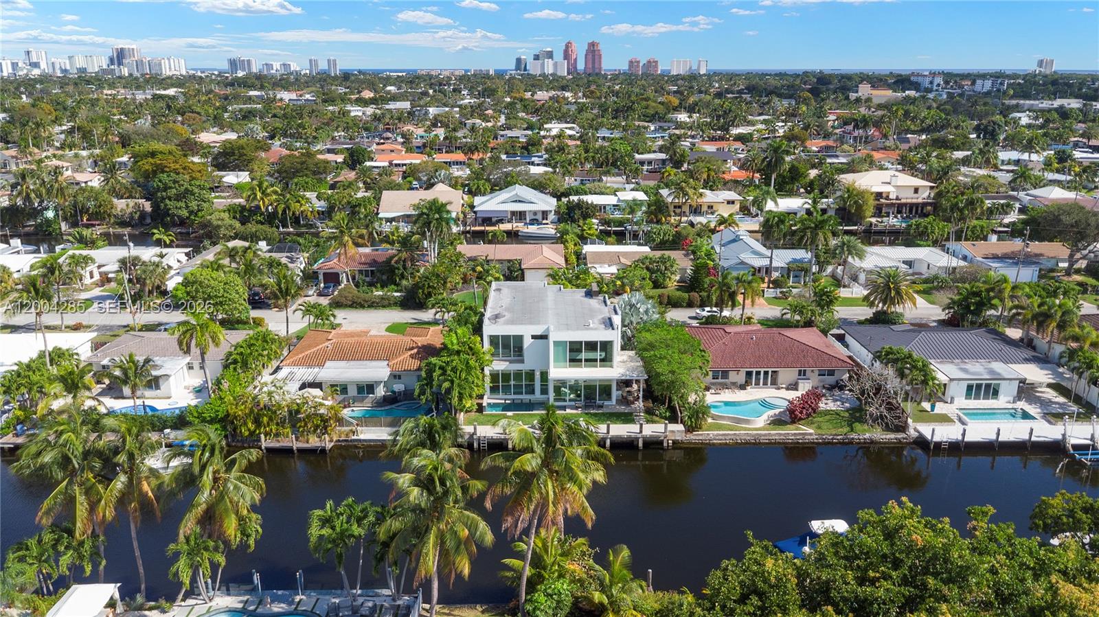 An aerial view shows a modern white house with a pool along a canal — 2217 NE 17th Ter, Wilton Manors FL 33305, WILTON MANORS, FL