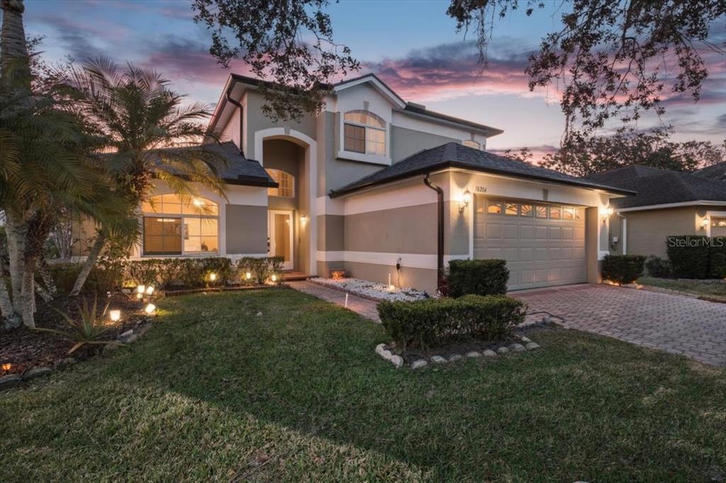 A living room features a brown sectional sofa, a glass coffee table, and a staircase — 16204 HAMPTON TRACE COURT, TAMPA, FL
