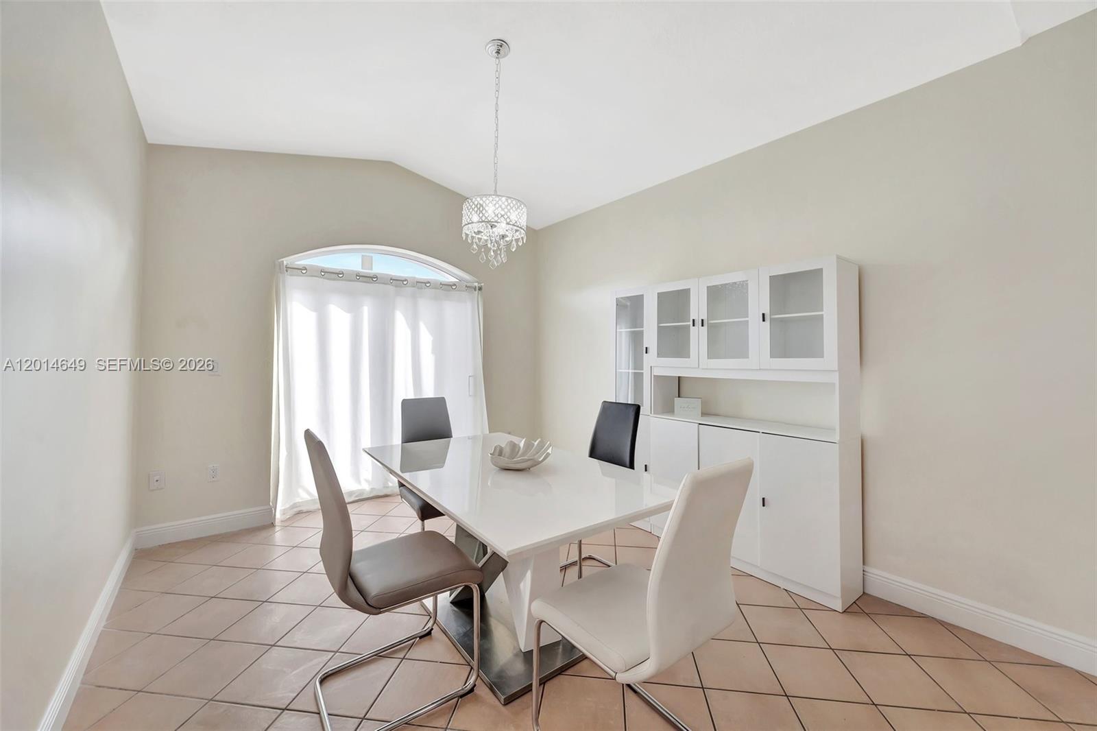 A dining room features a white table, four chairs, a hutch, and tile flooring — 10110 SW 154th Cir Ct # 1, Miami FL 33196, MIAMI, FL
