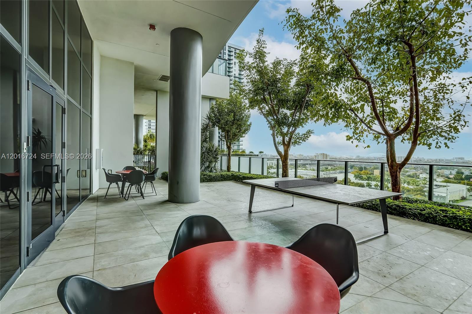 An outdoor terrace features a ping pong table, dining sets, and views of the city — 1600 NE 1st Ave # 1918, Miami FL 33132, MIAMI, FL