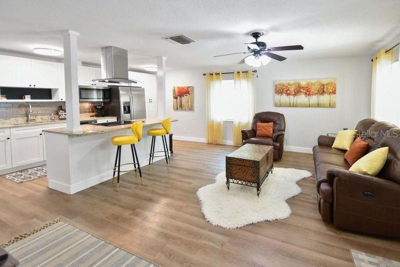 A backyard features a gazebo with teal chairs, a small table, and a detached garage — 418 40TH AVENUE S, ST PETERSBURG, FL