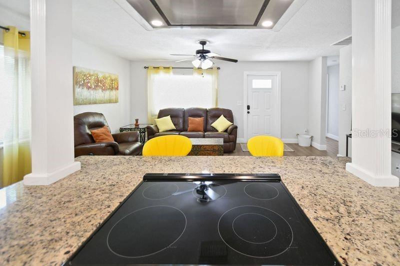 A light green single-story house features a yellow front door and a concrete patio — 418 40TH AVENUE S, ST PETERSBURG, FL