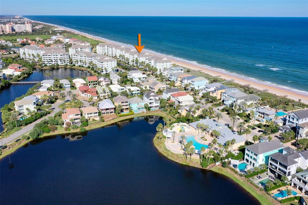 An aerial view shows a coastal resort community with a large pool and oceanfront buildings — 800 CINNAMON BEACH WAY UNIT 721, PALM COAST, FL