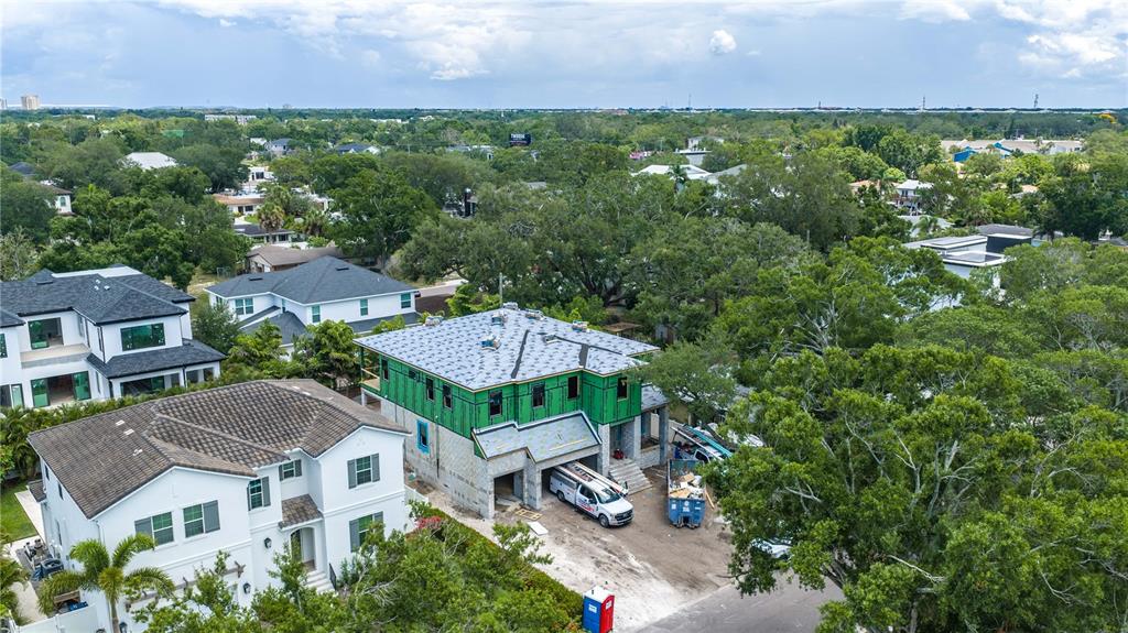 An aerial view shows a two-story house under construction next to a completed white home — 3618 S GARDENIA AVENUE, TAMPA, FL