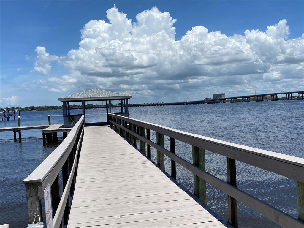 A wooden pier leads to a covered gazebo over a large body of water — 1600 1ST AVENUE W UNIT 206A, BRADENTON, FL