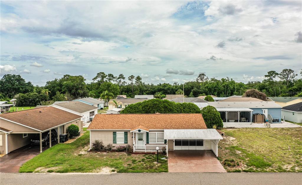 An aerial view of a single-story house with a brown roof and a carport — 4235 CERIMEN STREET, LAKE WALES, FL