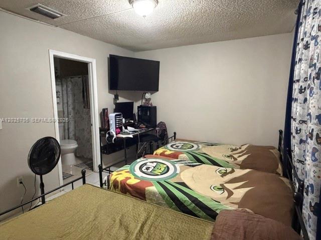 A bedroom features two twin beds with cartoon bedding, a desk area, and an attached bathroom — 4424 W 12th Ln # 7, Hialeah FL 33012, HIALEAH, FL