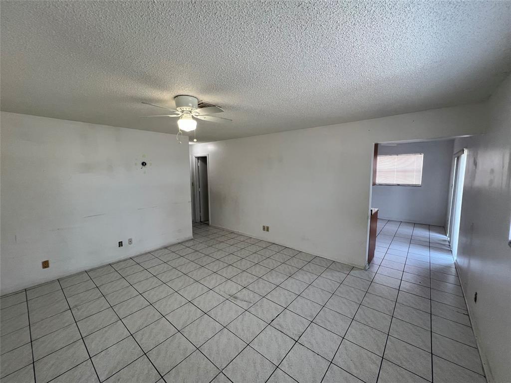 An empty room with white walls, a ceiling fan, and light-colored square floor tiles — 230 SW 1st Street # 8, Pompano Beach FL 33060, POMPANO BEACH, FL