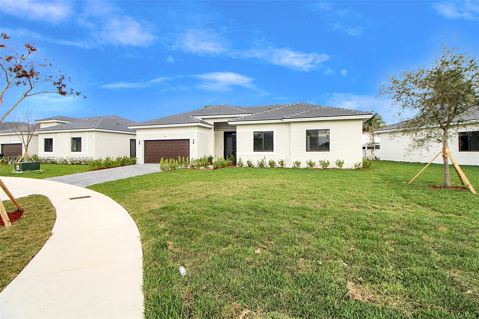 A single-story house with a dark garage door, light-colored exterior, and a manicured lawn — 20833 SW 96th Ct, Cutler Bay FL 33189, CUTLER BAY, FL