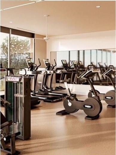 This rendering shows a modern fitness center with exercise machines, large windows, and mirrored walls — 601 NE 1st Ave # 1606, Miami FL 33132, MIAMI, FL