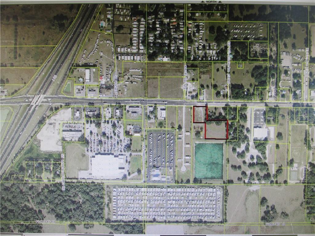 An aerial map shows two highlighted adjacent parcels of land near a highway and parking lots — County Road 48 W BELT AVENUE, BUSHNELL, FL