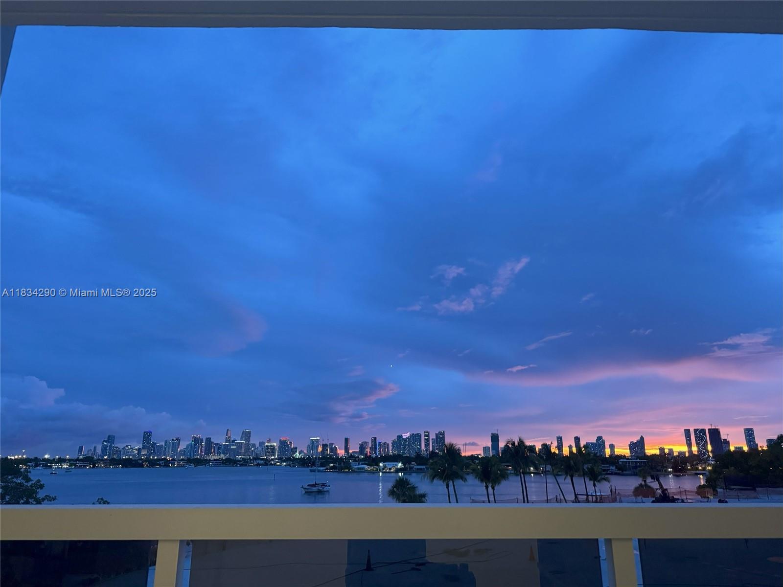 A view of a city skyline across a body of water at sunset — 9 Island Ave # 406, Miami Beach FL 33139, MIAMI BEACH, FL