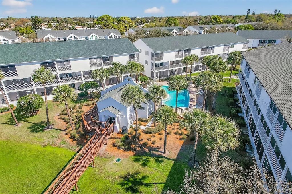 An aerial view shows a community pool, a small clubhouse, and multi-story apartment buildings — 14793 SEMINOLE TRAIL, SEMINOLE, FL