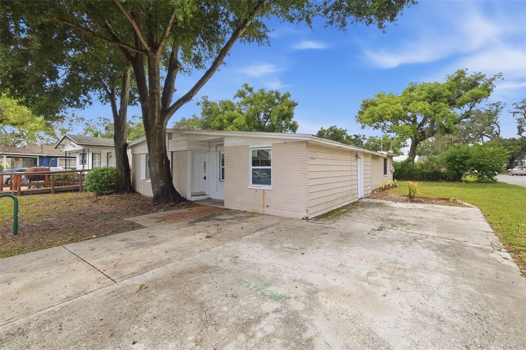 A single-story house with a beige brick and siding exterior and a concrete driveway — 4222 N 14TH STREET, TAMPA, FL