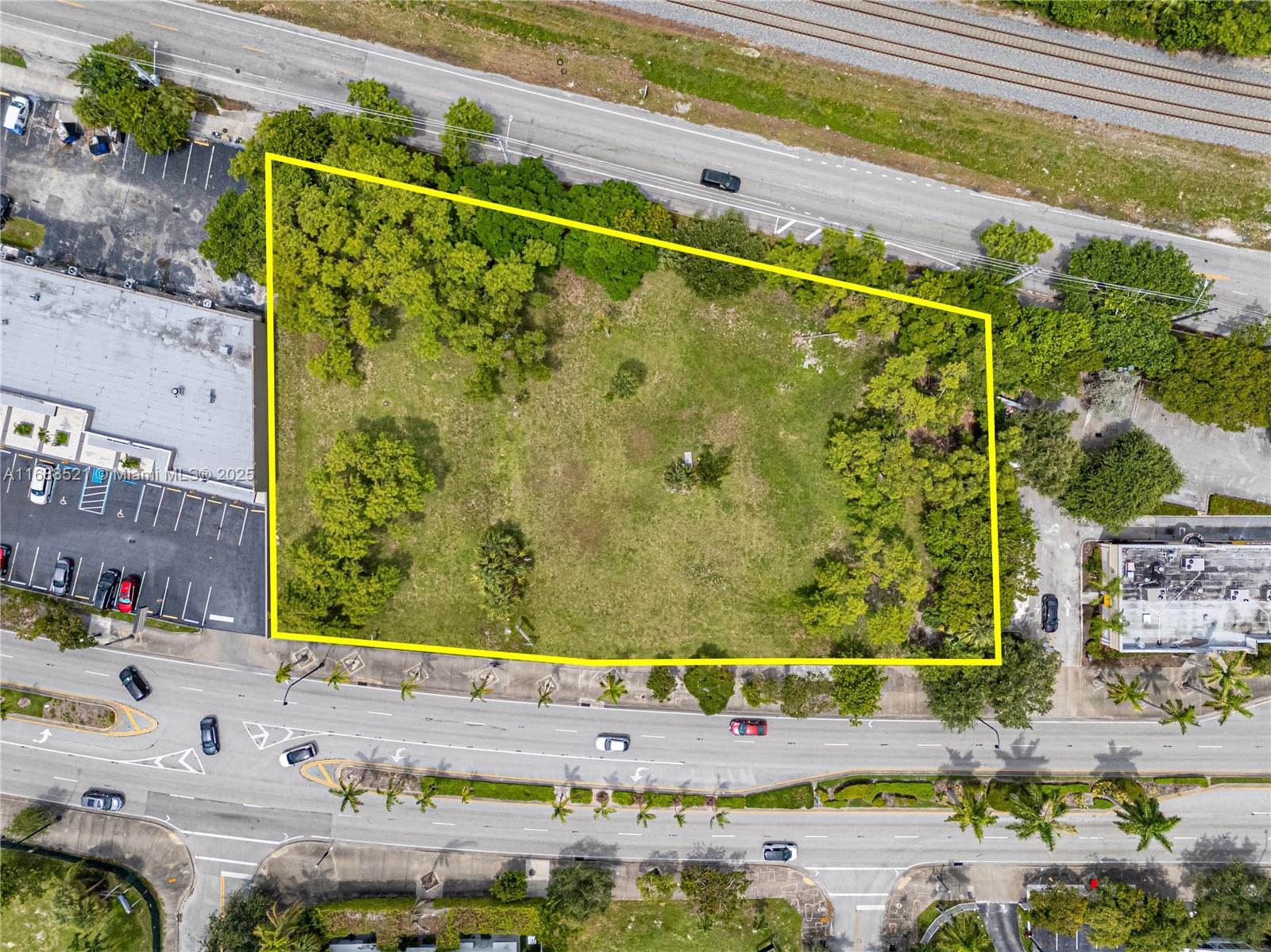 An aerial view shows a vacant, rectangular lot outlined in yellow between two commercial properties — 5220 Biscayne, Miami FL 33137, MIAMI, FL
