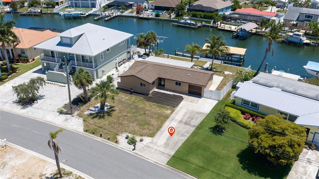 An aerial view shows a single-story house with a brown roof and a concrete driveway — 5108 COMMONWEALTH ROAD, PALMETTO, FL