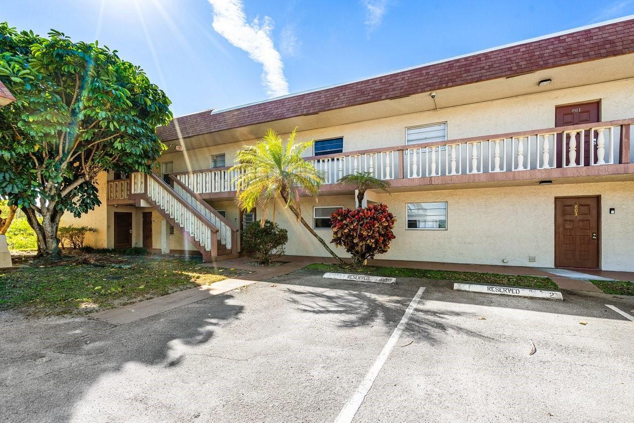 A two-story apartment building exterior with a parking lot, stairs, and balcony — 9280 SW 3rd Street # 802, Boca Raton FL 33428, BOCA RATON, FL