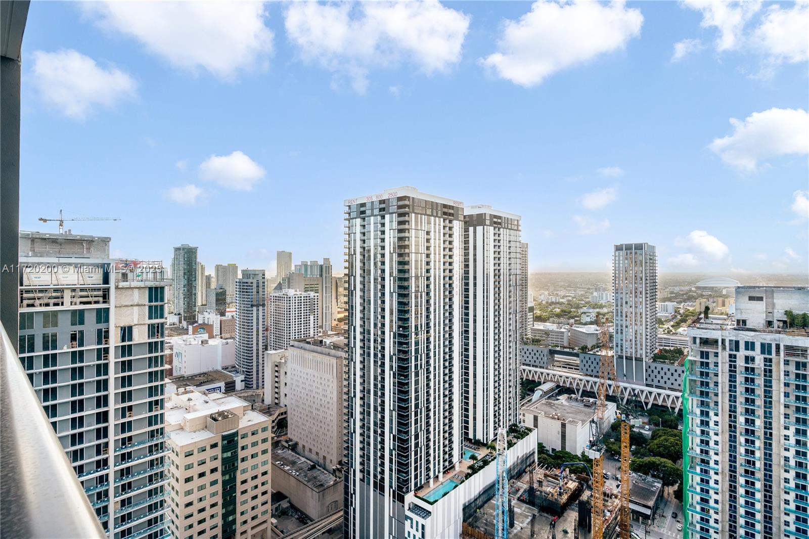 An elevated view of a dense urban skyline featuring several modern high-rise apartment buildings — 601 NE 1 AVE # 3604, Miami FL 33132, MIAMI, FL