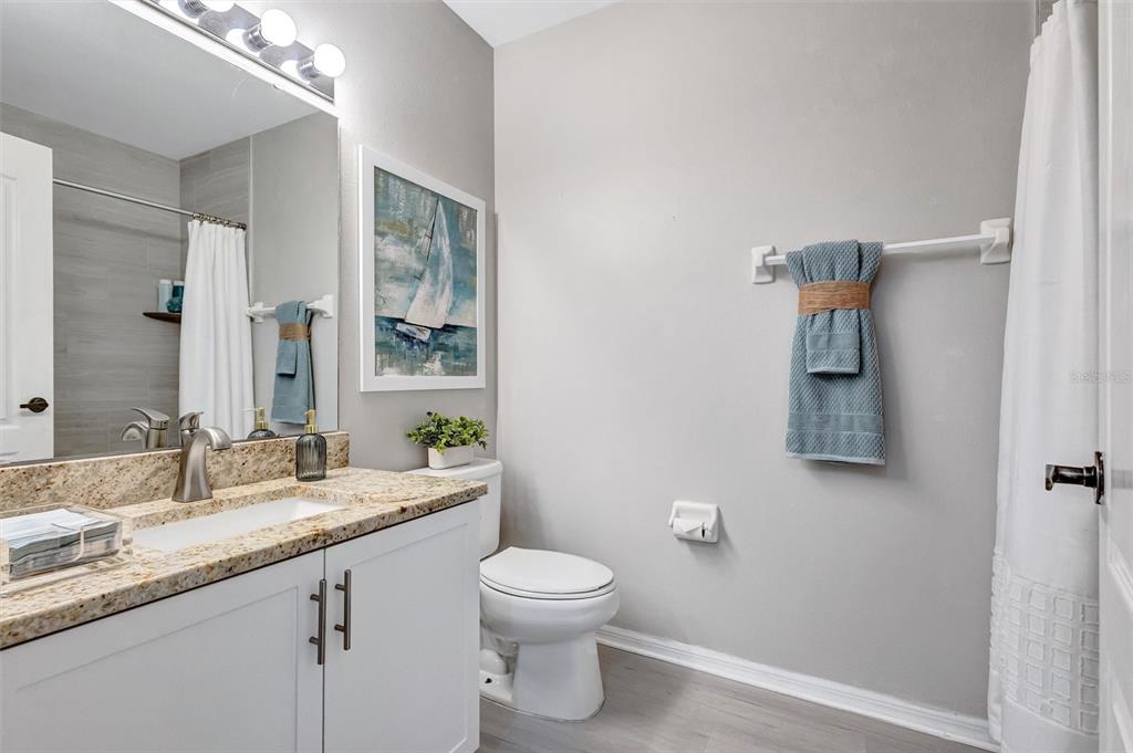 A living room features light-colored furniture, a patterned area rug, and a sliding glass door — 9620 CLUB SOUTH CIRCLE UNIT 5107, SARASOTA, FL