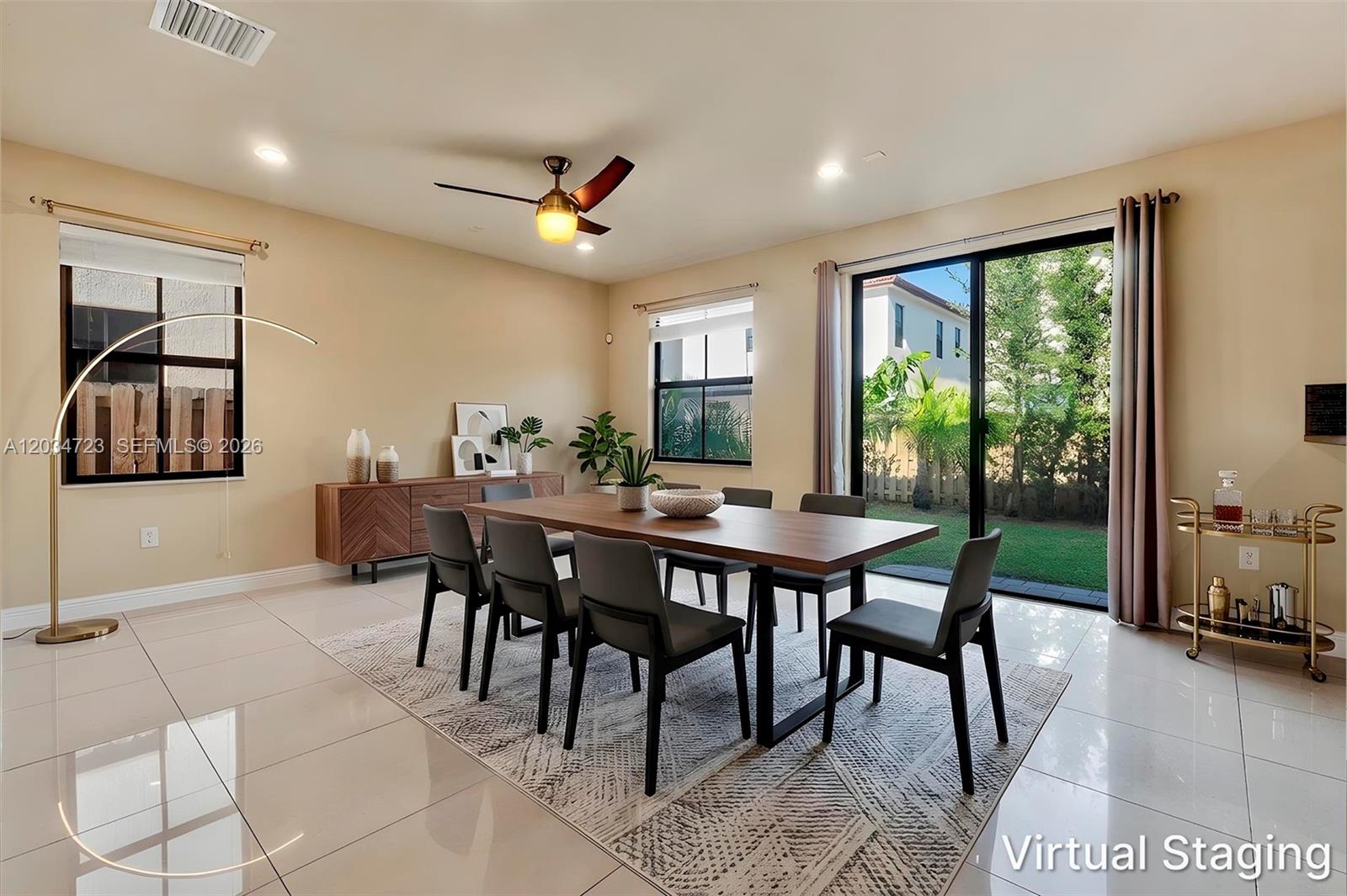 A dining room features a wooden table, six chairs, tile flooring, and a sliding glass door — 8890 NW 99th Path, Doral FL 33178, DORAL, FL