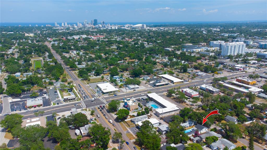 An aerial view shows a residential neighborhood with a red arrow pointing to a house — 3459 8TH AVENUE N, ST PETERSBURG, FL