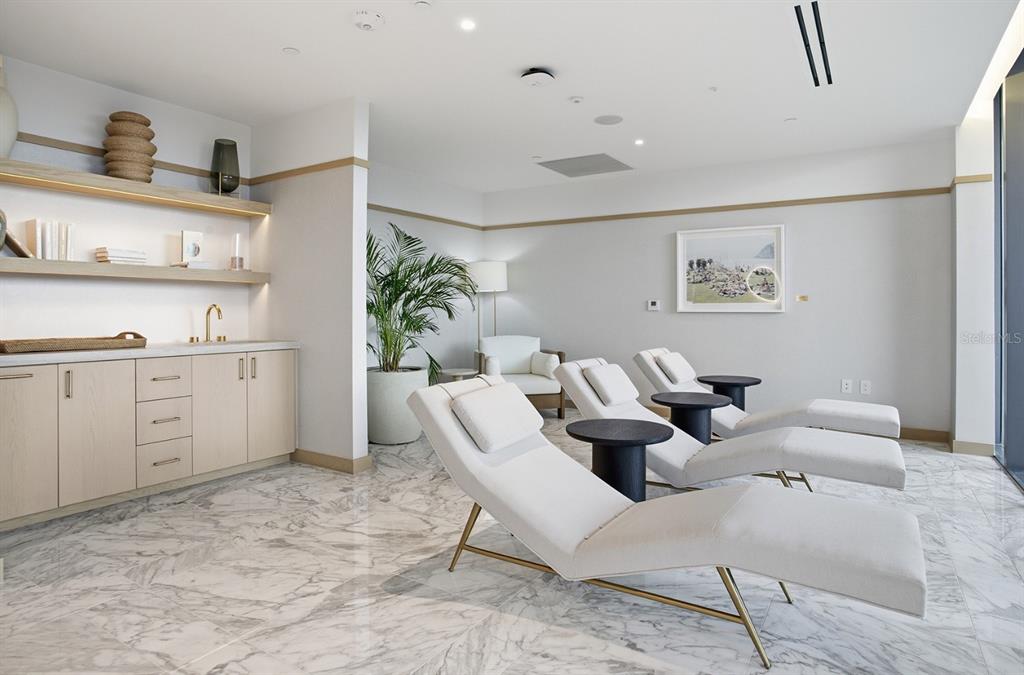 A modern hotel lobby features a wood-slatted ceiling, marble fireplace, and contemporary seating area — 3015 S YSABELLA AVENUE UNIT 603, TAMPA, FL